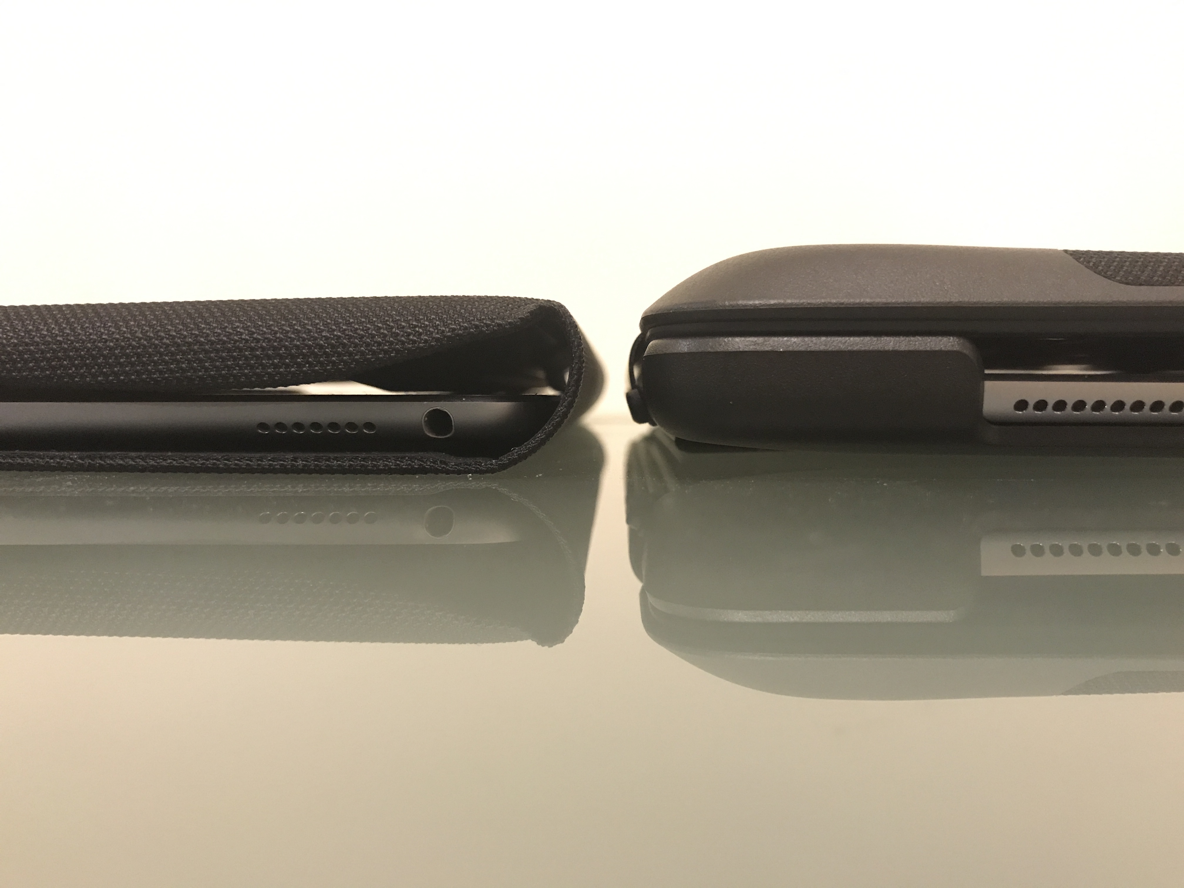 The side view of the Logitech case and the Apple Smart Keyboard next to each other. The Logitech case is about a third thicker than the Apple one.