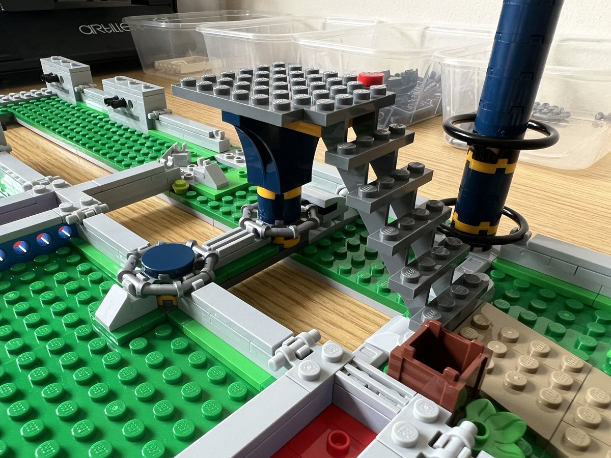 A set of lego stairs leading up to a small grey platform