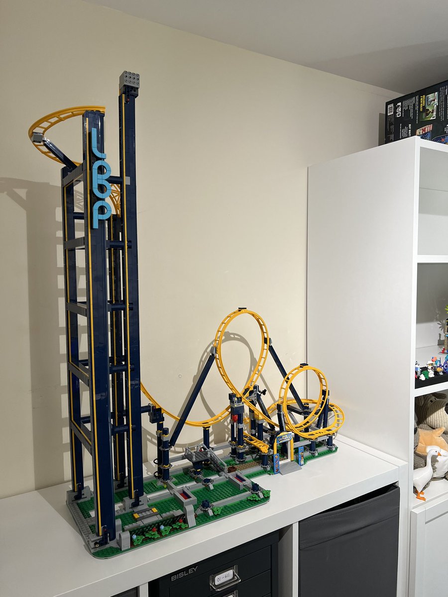 Another angle of the roller coaster showing it in scale next to a bookcase, with the tip of the lift tower taller than the bookcase nearly reaching the ceiling.